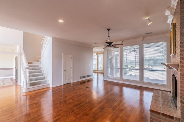 128 Oakview Dr, Hudson Oaks, TX 76087 - unfurnished living room with a fireplace, a ceiling fan, stairway, wood finished floors, and ornamental molding
