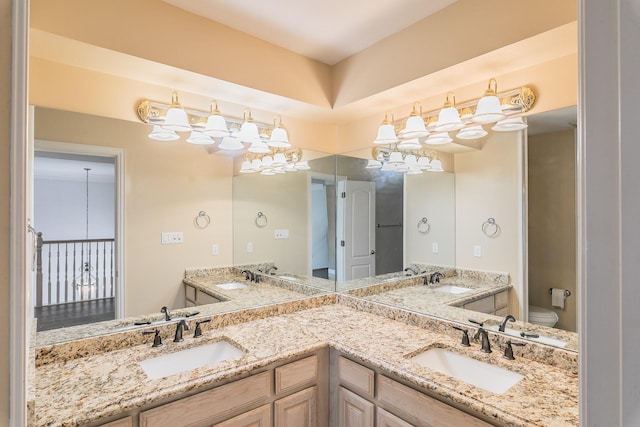 128 Oakview Dr, Hudson Oaks, TX 76087 - bathroom featuring toilet, double vanity, and a chandelier