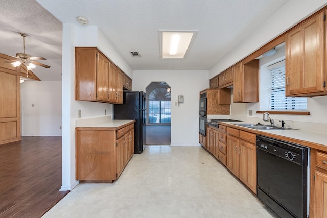 7425 Dana Ln, North Richland Hills, TX 76182 - kitchen with a wealth of natural light, visible vents, a sink, and black appliances