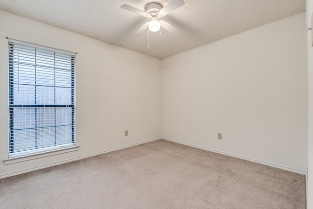7425 Dana Ln, North Richland Hills, TX 76182 - unfurnished room with a healthy amount of sunlight, light carpet, ceiling fan, and a textured ceiling