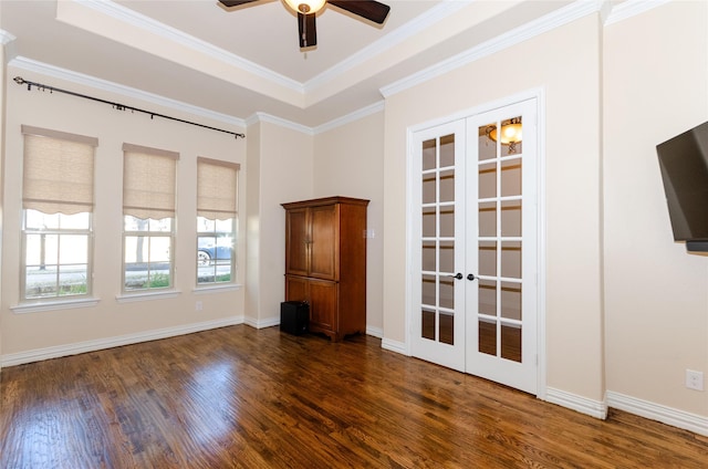 unfurnished room featuring dark wood-type flooring, baseboards, ornamental molding, french doors, and a tray ceiling