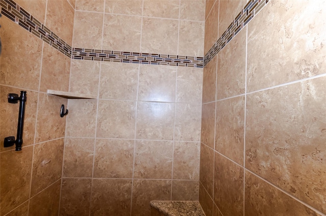 interior details with a tile shower