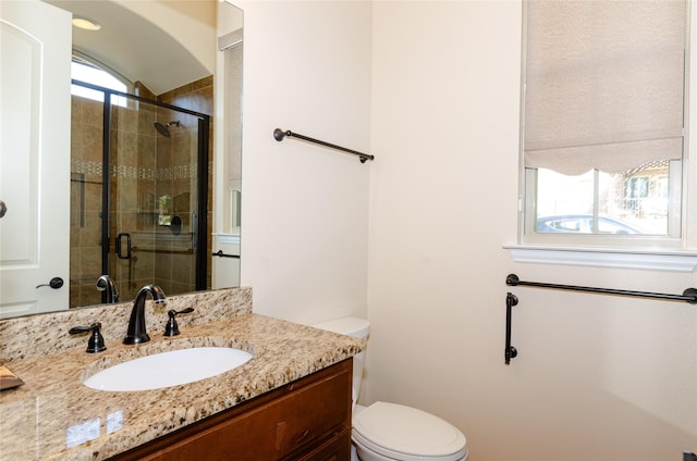 full bathroom with toilet, a shower stall, and vanity