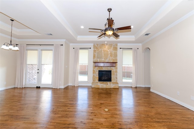 unfurnished living room featuring a raised ceiling, visible vents, and a fireplace