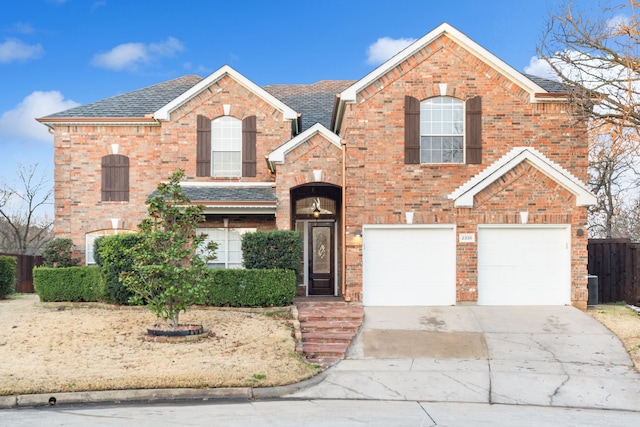 view of front of house featuring a garage, brick siding, and driveway