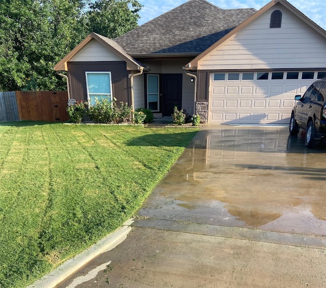 single story home featuring a shingled roof, concrete driveway, an attached garage, fence, and a front lawn