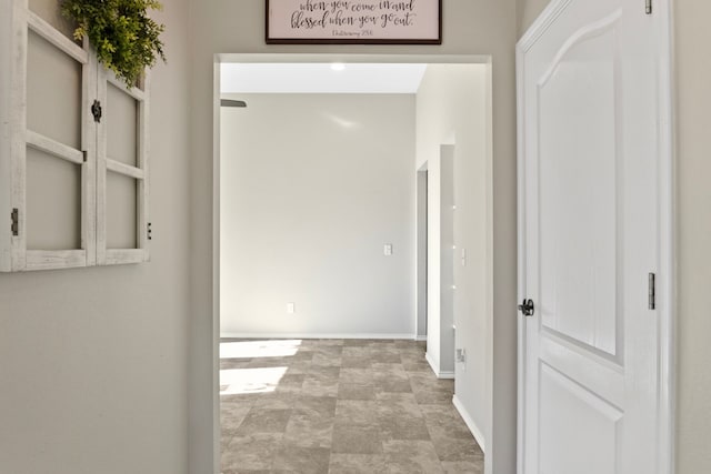 hallway featuring baseboards