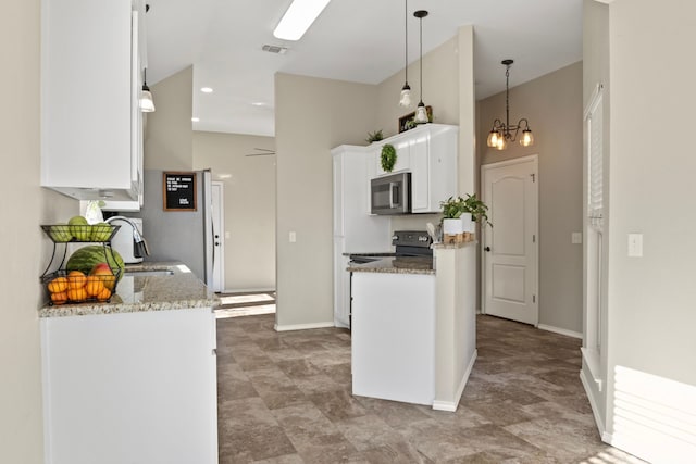 kitchen featuring light stone counters, stainless steel microwave, an inviting chandelier, white cabinets, and a sink