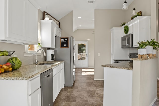 kitchen with light stone counters, stainless steel appliances, white cabinetry, pendant lighting, and a sink