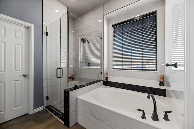 full bathroom with a stall shower and a garden tub