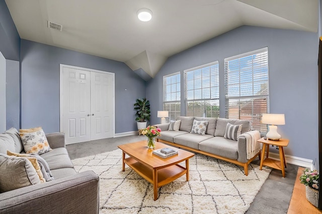 living room featuring visible vents, vaulted ceiling, and baseboards