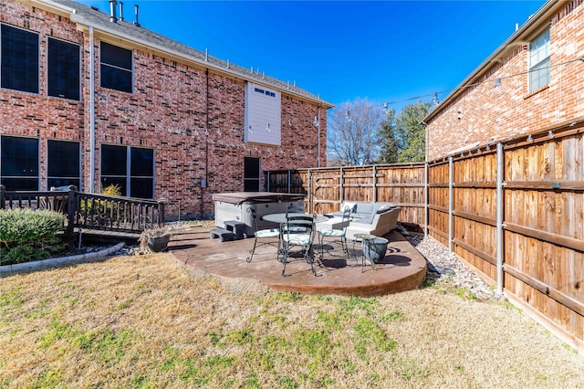 view of yard with a patio area, a fenced backyard, and a hot tub