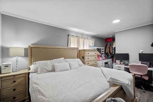 bedroom featuring ornamental molding, a closet, and wood finished floors