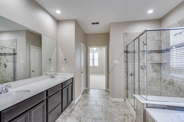 full bath with visible vents, a sink, and a shower stall