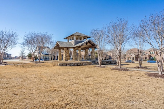 view of property's community with a yard and a gazebo