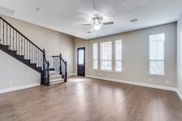 entryway with plenty of natural light, visible vents, stairway, and wood finished floors