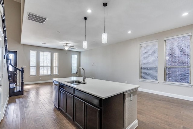 kitchen featuring visible vents, dark wood-type flooring, open floor plan, a sink, and dishwasher