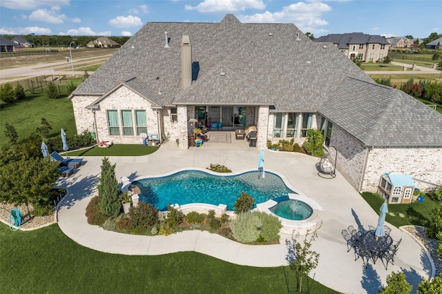 outdoor pool with a patio area, a fenced backyard, and a lawn