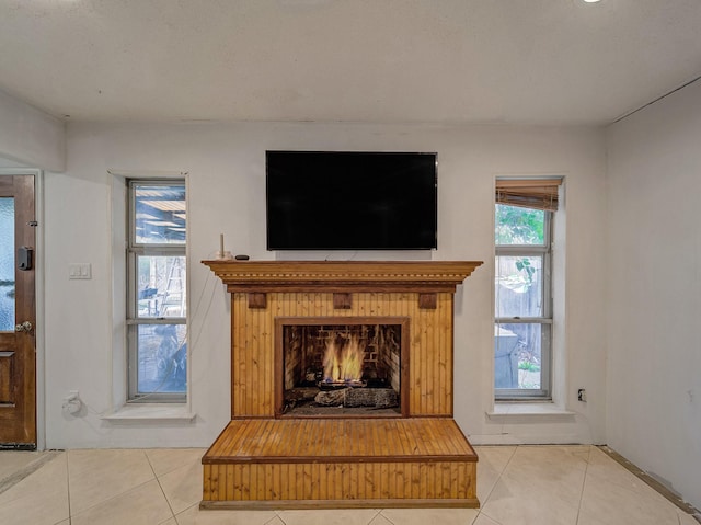 interior details featuring a lit fireplace