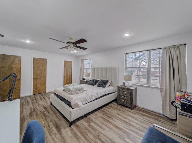 bedroom with a ceiling fan, recessed lighting, visible vents, and light wood finished floors