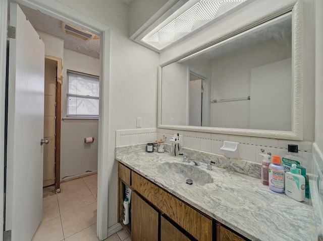 bathroom featuring tile patterned flooring, visible vents, decorative backsplash, and vanity