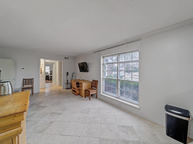 living area with baseboards, visible vents, and light tile patterned flooring