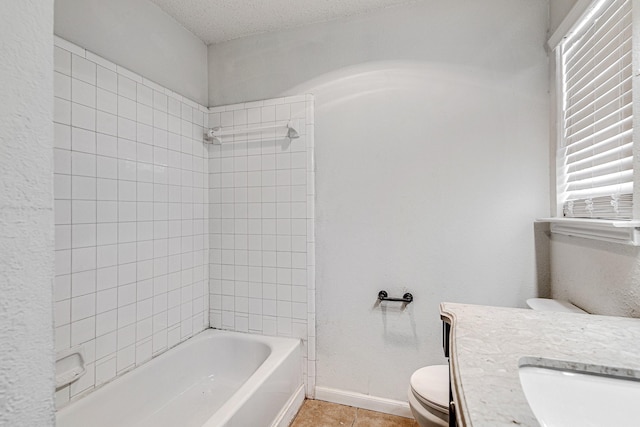 full bath featuring baseboards, toilet, shower / bathtub combination, tile patterned floors, and a textured ceiling