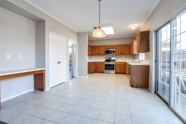 kitchen featuring brown cabinetry, appliances with stainless steel finishes, ornamental molding, light countertops, and a sink