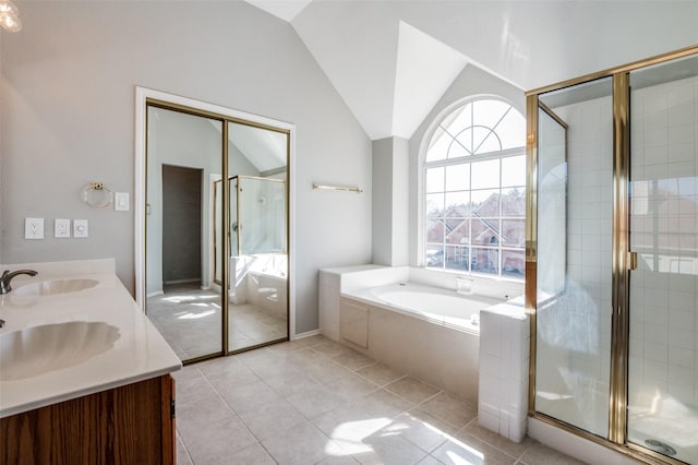 full bath featuring lofted ceiling, a stall shower, a sink, and a bath