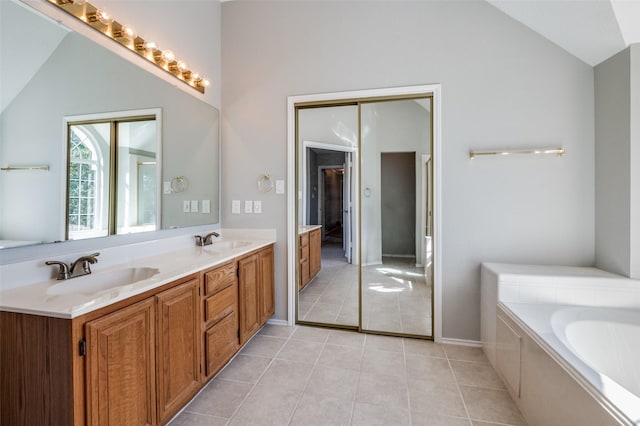 full bathroom featuring vaulted ceiling, double vanity, a sink, and tile patterned floors