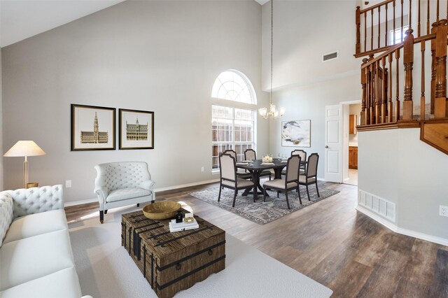 unfurnished living room with baseboards, stairs, visible vents, and wood finished floors