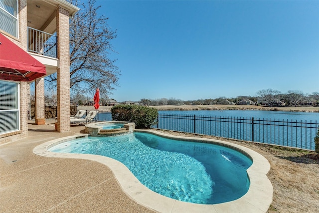 view of swimming pool featuring a pool with connected hot tub, a water view, a patio, and a fenced backyard