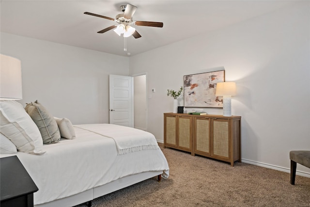 bedroom with a ceiling fan, light colored carpet, and baseboards