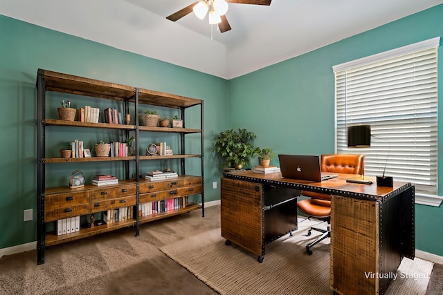 office space featuring carpet flooring, ceiling fan, and baseboards