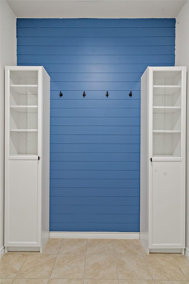 mudroom featuring baseboards and light tile patterned floors