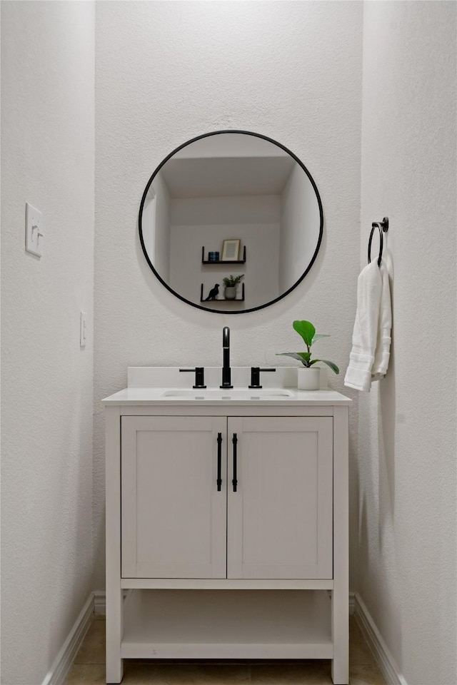 bathroom featuring baseboards and vanity