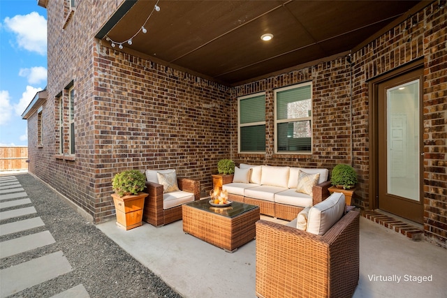 view of patio featuring fence and an outdoor hangout area