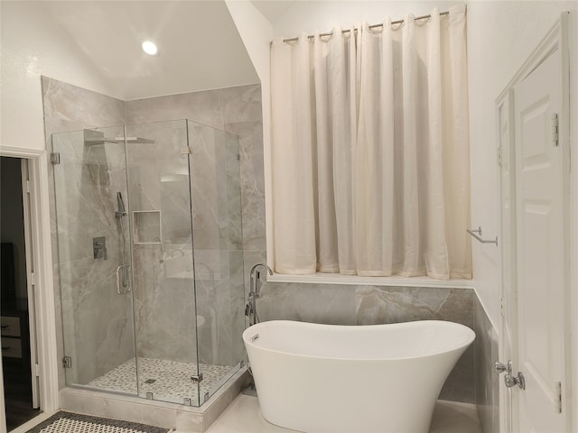 full bath with a stall shower, a freestanding bath, and recessed lighting