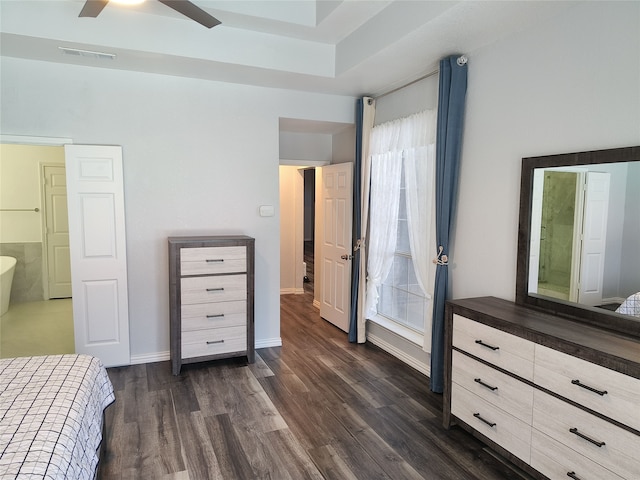 unfurnished bedroom featuring dark wood-style floors, baseboards, visible vents, and ceiling fan