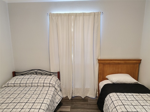 bedroom featuring dark wood-style floors