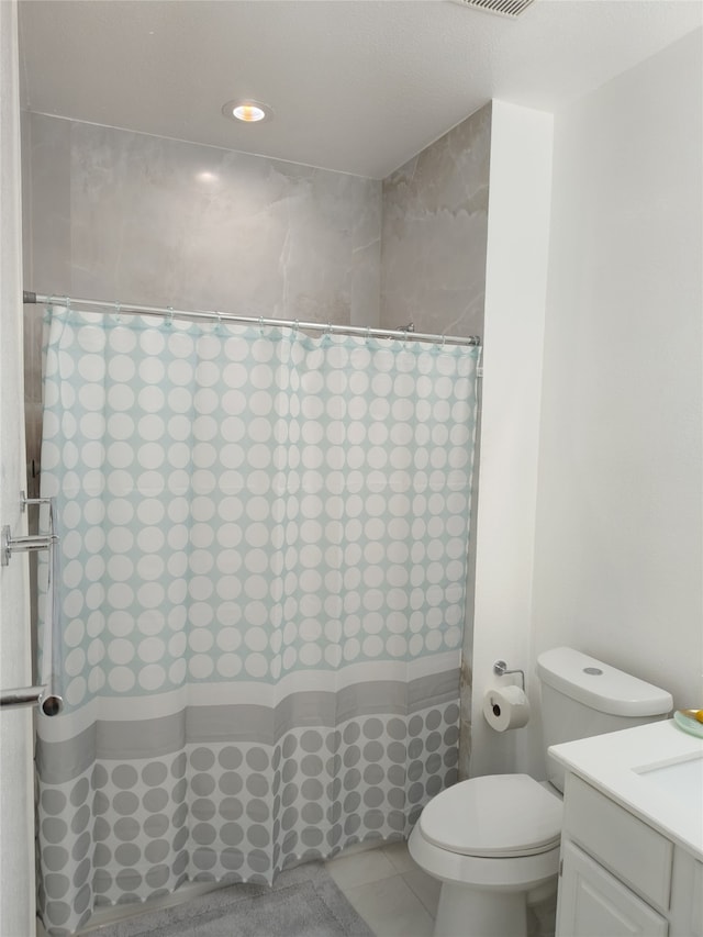 full bathroom with curtained shower, vanity, toilet, and tile patterned floors