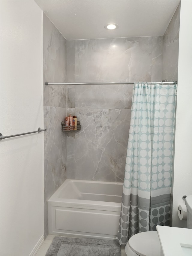 full bathroom featuring toilet and shower / bath combo with shower curtain