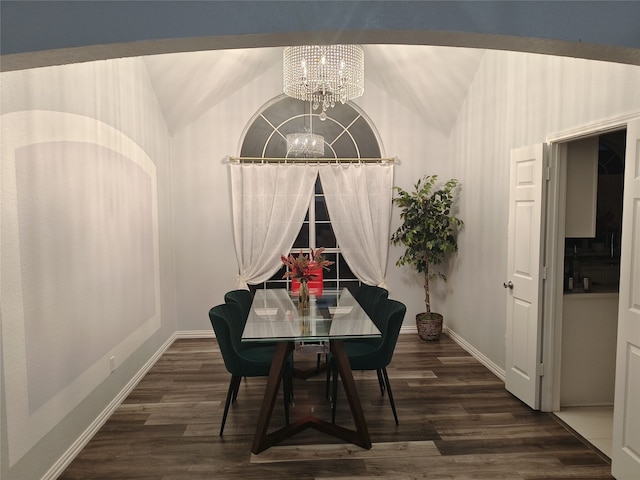 dining space featuring vaulted ceiling, baseboards, wood finished floors, and an inviting chandelier