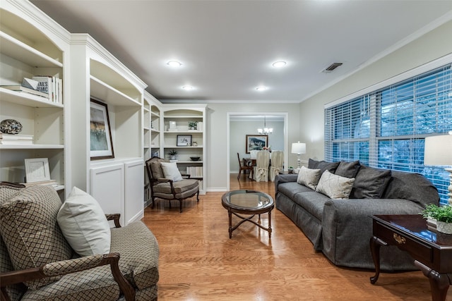 living area featuring recessed lighting, visible vents, light wood finished floors, an inviting chandelier, and crown molding