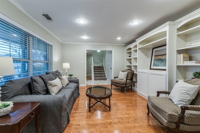 living room with recessed lighting, visible vents, ornamental molding, stairway, and light wood-type flooring