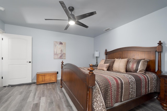 bedroom with visible vents, ceiling fan, baseboards, and wood finished floors