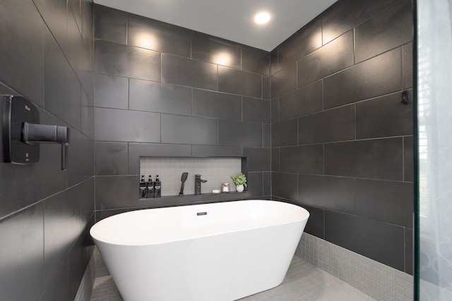 full bathroom featuring a freestanding tub, tile walls, and recessed lighting