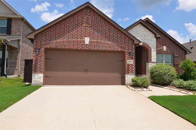 view of front facade with stone siding, brick siding, an attached garage, and driveway