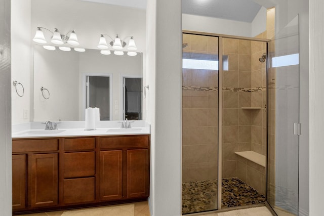 full bathroom featuring a sink, a shower stall, and double vanity