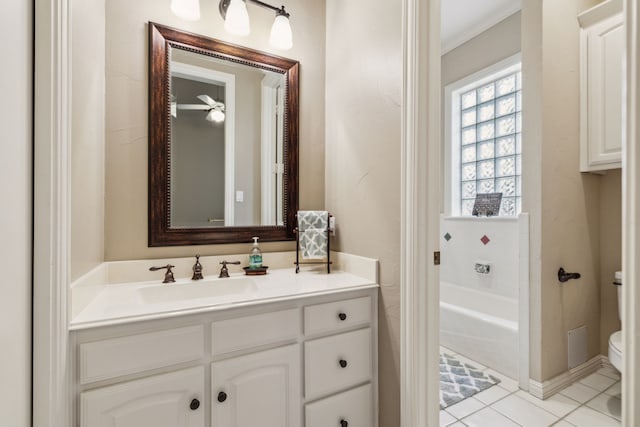 full bathroom with tile patterned flooring, toilet, vanity, ornamental molding, and a bathtub